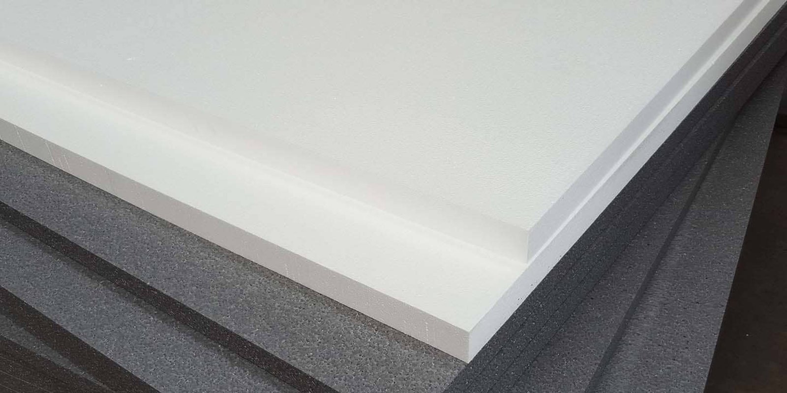 Foam board insulation panels stacked on an Auckland home renovation site with an exposed timber subfloor