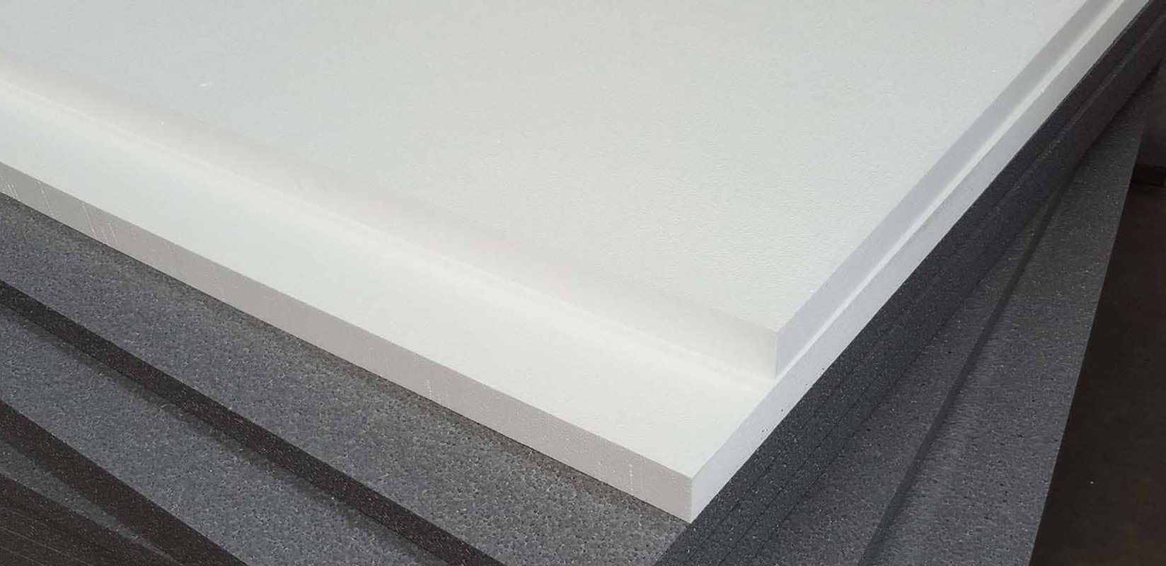 Foam board insulation panels stacked on an Auckland home renovation site with an exposed timber subfloor