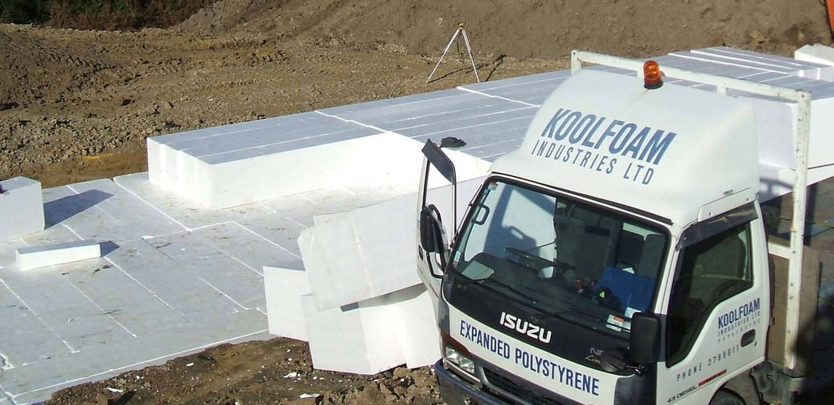Stacked lightweight EPS Geofoam blocks being placed as structural fill on a civil construction site
