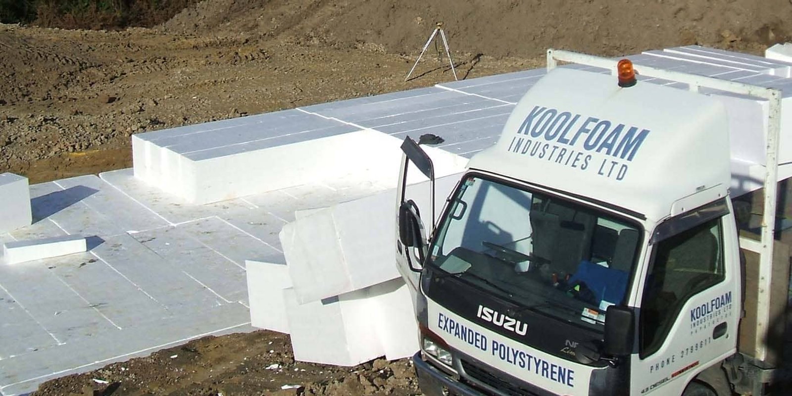 Stacked lightweight EPS Geofoam blocks being placed as structural fill on a civil construction site